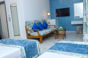 a hotel room with a couch and a tv at Riviera tibarose in Marsa Matruh