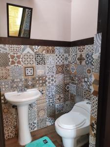 a bathroom with a toilet and a sink at GREEN ORCHID HOSTEL Miraflores Lima in Lima