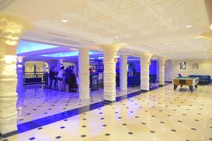 a lobby with columns and a pool table in a building at Monarque Dar Jerba Narjess in Taguermess