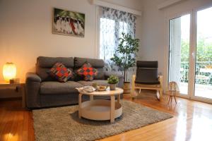 a living room with a couch and a table at Alimos House in Athens
