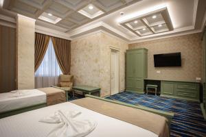 Postel nebo postele na pokoji v ubytování Ervini Boutique Hotel
