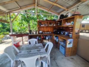 a kitchen with a table and a table and chairs at Camping Babsita-TIPI und Hütten und Stellplätze für Zelt und Camper direkt am Meer und See in Tuba Creek