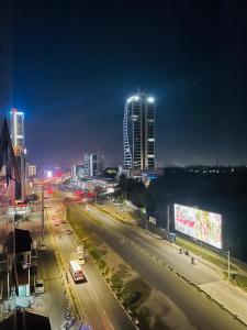 a city street at night with buildings and street lights at Convenient city apartment with free WiFi in Dar es Salaam