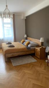 a bedroom with a large bed and a window at Anenska by Charles Bridge 3 in Prague