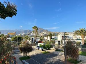a view of a city with palm trees and buildings at Fantastic vacation by the ocean in Playa de las Americas