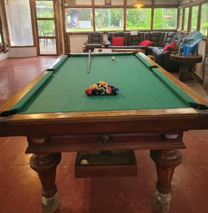 a pool table with balls on it in a room at Finca La Rivera in San Agustín