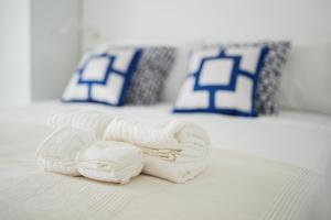 two towels are laying on top of a bed at Ammore Ammare Apartment in Ischia Town