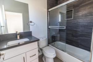 a bathroom with a toilet and a sink and a shower at Ktown Homestay in Los Angeles