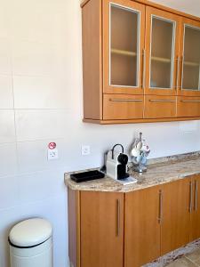 a kitchen with wooden cabinets and a counter top at LA BARRACA - Ideal para familias y adultos responsables en busca de tranquilidad no se permiten fiestas in Mojácar