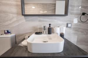 a bathroom with a white sink and a toilet at Select Cunda Guest House - Sea View Room with Private Veranda in Cunda Island in Ayvalık +46 photos