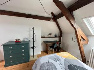 a bedroom with a green dresser and a desk at Clos Sanouva, Fougère in Le Breuil-en-Auge