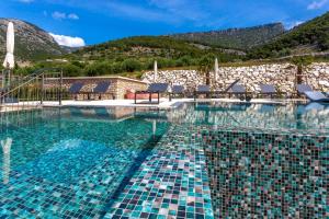 a pool at a resort with mountains in the background at Grey House in Bol