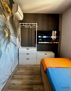 a bedroom with a tv and a bed at ADOME Apartment Primavera in Santa Pola