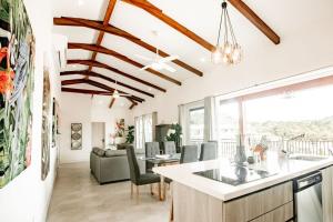 a kitchen and living room with wooden ceilings at Blue Venao PENTHOUSE APARTMENT B in Playa Venao