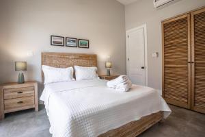 a bedroom with a large bed with towels on it at Villa #36 - Blue Venao, Playa Venao in Playa Venao