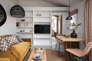 a living room with a couch and a table at Kittiwake apartment - Coastal, luxury, self-catering in Port Isaac