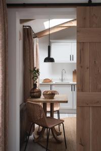 a kitchen with a table and chairs and a sink at Kittiwake apartment - Coastal, luxury, self-catering in Port Isaac