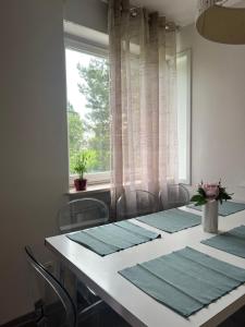 a dining room table with chairs and a window at Apartment Ljubljana - Free parking in Ljubljana
