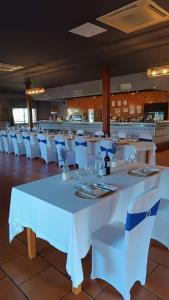 San Martín de MontalbánHostal San Martin de Montalban的用餐室配有白色的桌子和白色的椅子