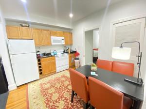 uma cozinha com uma mesa e um frigorífico branco em Gorgeous Refurbished 1Bdrm and 1Den Home em Washington