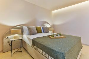 a bedroom with a large bed and a side table at Boutique hotel Ruzmarin SPA & Garden by Aycon in Budva