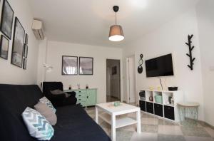 a living room with a couch and a table at Mar y montaña in Monachil +8 photos