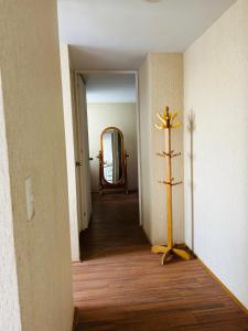 a hallway with a cross on the floor and a mirror at Departamento en Condominio Comas in Lima