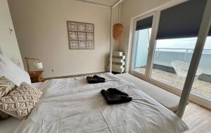 Postel nebo postele na pokoji v ubytování COAST HOUSE Sky Suite