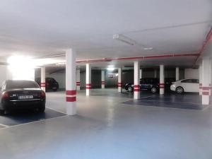a parking garage with cars parked in it at Loft BAINIS Peregrinos & Uso Turístico in A Guarda