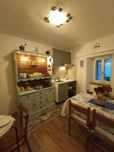 a kitchen with a table and a kitchen with a table and a tableablish at Alla Bifora in Muggia +17 photos
