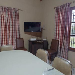 a room with a table and chairs and a flat screen tv at Casa San Lucas in San Rafael +15 photos