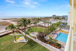 an aerial view of a resort with a swimming pool and the beach at South Beach Condo Hotel by Travel Resort Services, Inc. in St. Pete Beach