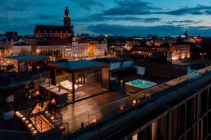 a rooftop deck with a hot tub on a building at EXCLUSIVE Aparthotel MARINA in Wrocław