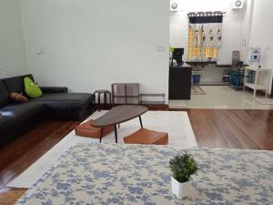 a living room with a couch and a table at La wood homestay in Kuala Besut