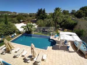 a swimming pool with chaise lounge chairs and a swimming pool at DAR BELDI in Hammamet