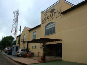 a building with a sign on the side of it at Tacuru Hotel Boutique in Salto del Guairá