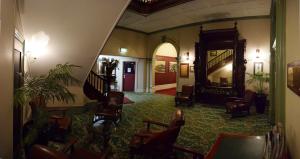a living room filled with lots of furniture at The Palace Hotel Kalgoorlie in Kalgoorlie