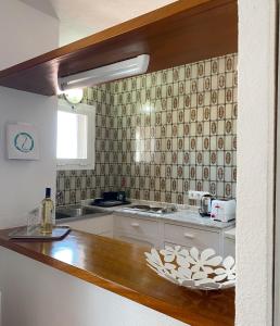 a kitchen with a sink and a counter top at Zodiac Apartments in Es Cana