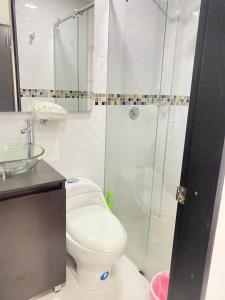 a bathroom with a toilet and a glass shower at casa vacacional en Anapoima in Anapoima +28 photos