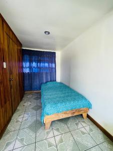 a bedroom with a bed in the corner of a room at Cabinas Nuestra Kasa in Monteverde Costa Rica