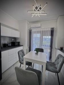 a kitchen and dining room with a table and chairs at Cozy Apartament in Center of Bucharest in Bucharest
