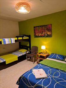 a bedroom with two bunk beds and a chair at Hostel Shalom Adonai in Cartagena de Indias