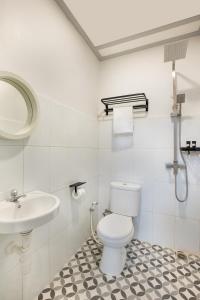 a bathroom with a toilet and a sink at CERIA HOTEL at Alun Alun Yogyakarta in Yogyakarta