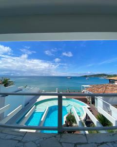 a view of the ocean from the balcony of a house at Villa Romana Búzios in Búzios