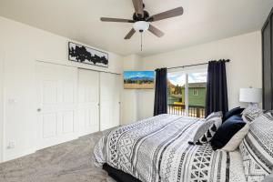 a bedroom with a bed and a ceiling fan at New Flagstaff Adventure Getaway in Flagstaff