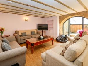 a living room with two couches and a tv at The Coach House in Newcastle upon Tyne