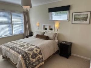 a bedroom with a large bed and a window at Cambridge Cottage - Self Catering Holiday House in Cambridge