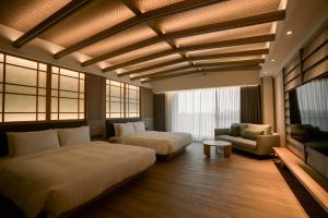 Posteľ alebo postele v izbe v ubytovaní XIUXI Anping Hotel