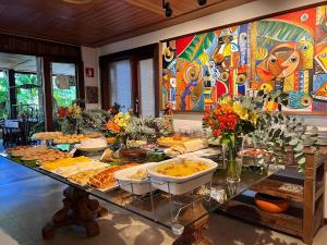 a buffet of food on a table in a room at Pousada João Sol in Praia do Forte