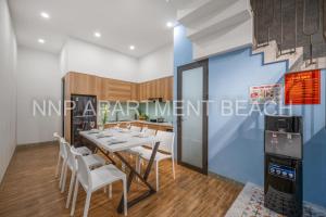 a dining room with a table and chairs at NNP Apartment Beach. in Da Nang +27 photos